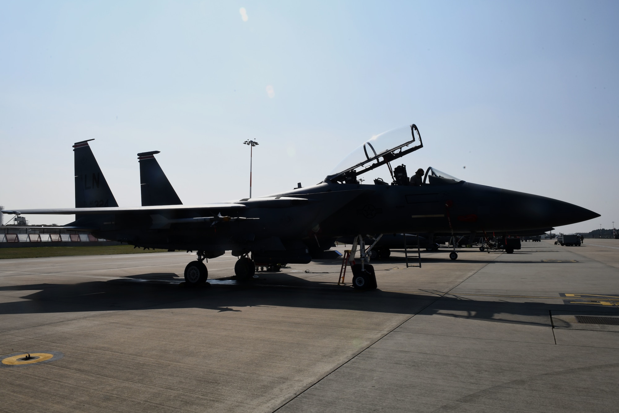 A 494th Aircraft Maintenance Unit crew chief cleans an F-15E Strike Eagle to prevent the spread of COVID-19 at Royal Air Force Lakenheath, England, April 16, 2020. The task requires everything inside the cockpit to be sanitized, to include any tool, button or switch the aircrew may have come in contact with during their flight. (U.S. Air Force photo by Senior Airman Christopher S. Sparks)