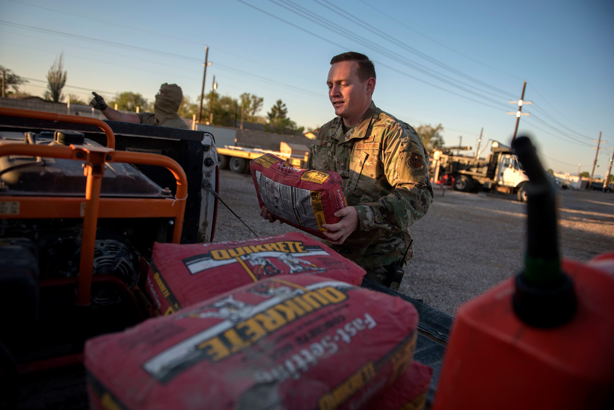 Staff Sgt. Jacob Drake, 49th Civil Engineer Squadron pavements and construction equipment operator, loads fast setting concrete into a pickup truck on Holloman Air Force Base, N.M., April 11, 2020. Pavements and construction personnel are still working around-the-clock, ensuring the airfield and base roads are clear of debris and repaired, allowing F-16 Viper and MQ-9 Reaper aircrew training operations to continue. (U.S. Air Force photo by Staff Sgt. Christine Groening)