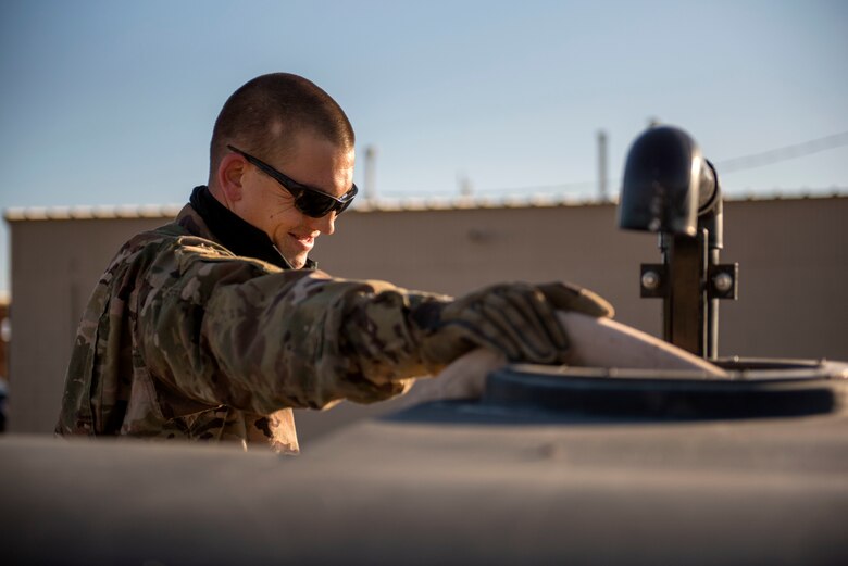 Staff Sgt. Adam Cox, 49th Civil Engineer Squadron pavements and construction equipment operator, fills a water buffalo on Holloman Air Force Base, N.M., April 11, 2020. While on site, pavements and construction personnel mixed concrete and water prior to setting. (U.S. Air Force photo by Staff Sgt. Christine Groening)