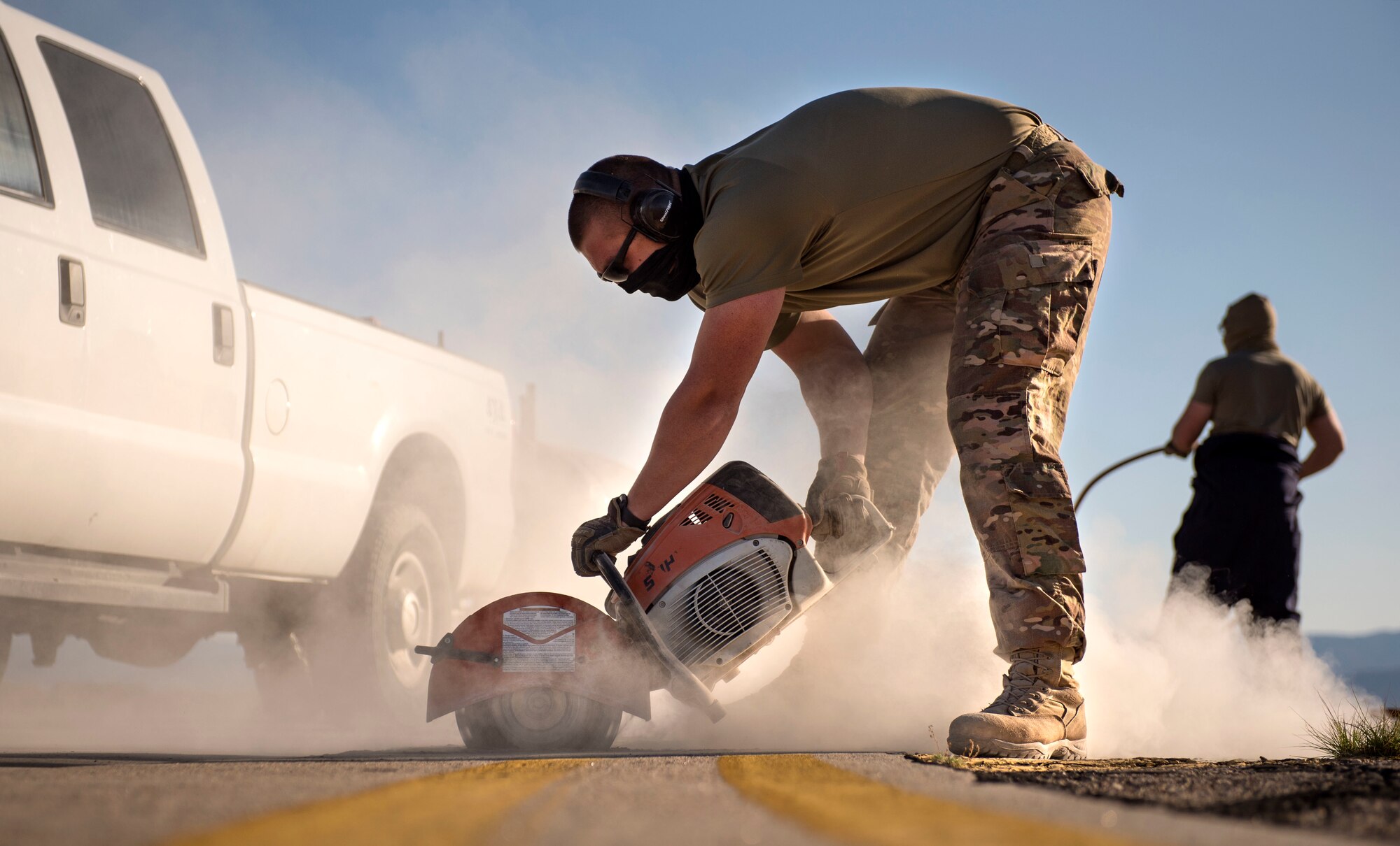Staff Sgt. Adam Cox, 49th Civil Engineer Squadron pavements and construction equipment operator, saws around a defected area on the flightline on Holloman Air Force Base, N.M., April 11, 2020. Cox and his team replaced a break in the concrete to prevent any safety hazards from occurring during future flightline operations. (U.S. Air Force photo by Staff Sgt. Christine Groening)