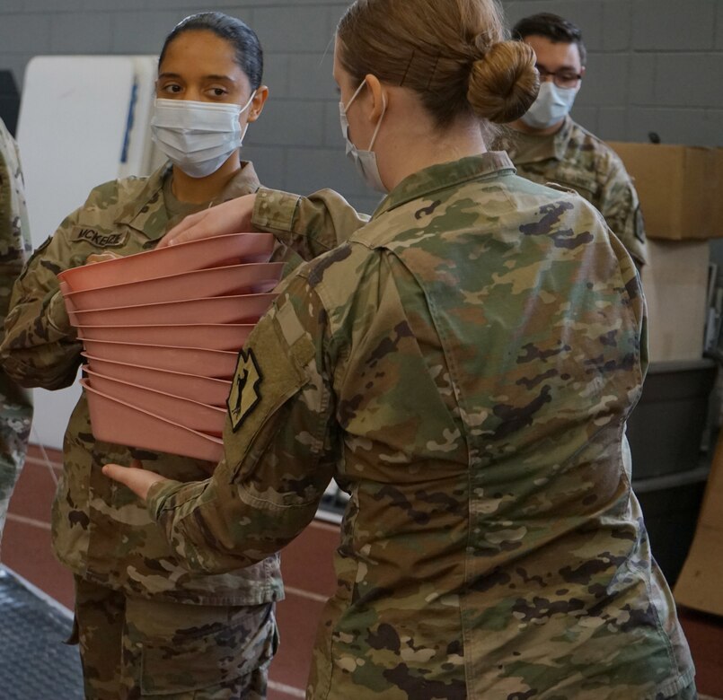 Soldiers from the Pennsylvania National Guard help unload supplies from a Pennsylvania Department of Health trailer at East Stroudsburg University's Koehler Fieldhouse on April 14, 2020.