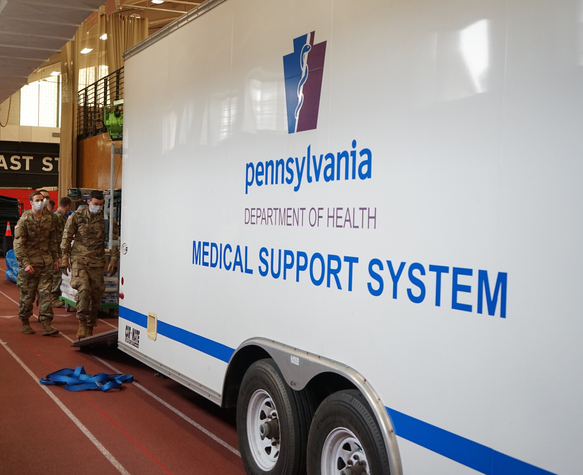 Soldiers from the Pennsylvania National Guard help unload supplies from a Pennsylvania Department of Health trailer at East Stroudsburg University's Koehler Fieldhouse on April 14, 2020.