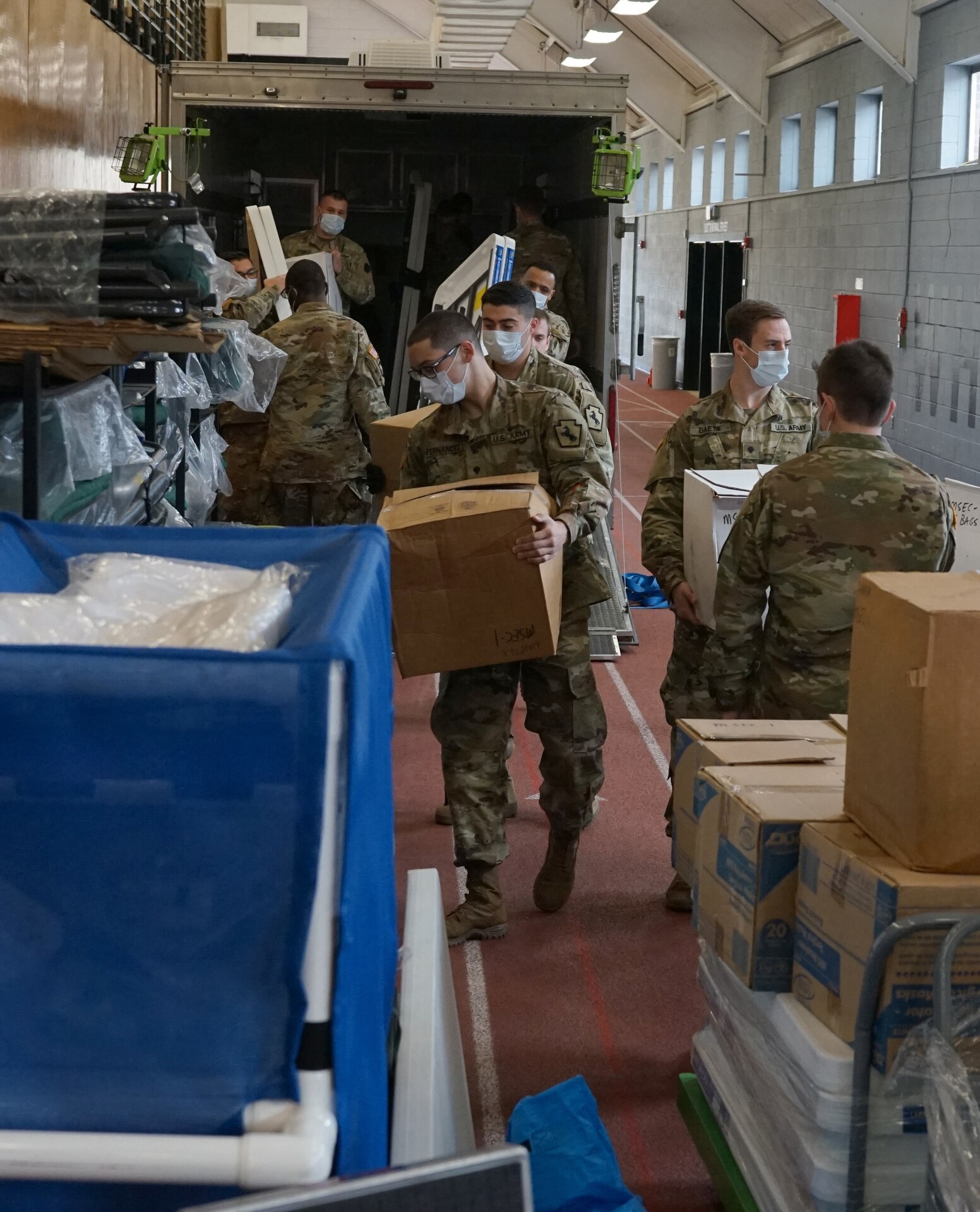 Soldiers from the Pennsylvania National Guard help unload supplies from a Pennsylvania Department of Health trailer at East Stroudsburg University's Koehler Fieldhouse on April 14, 2020.