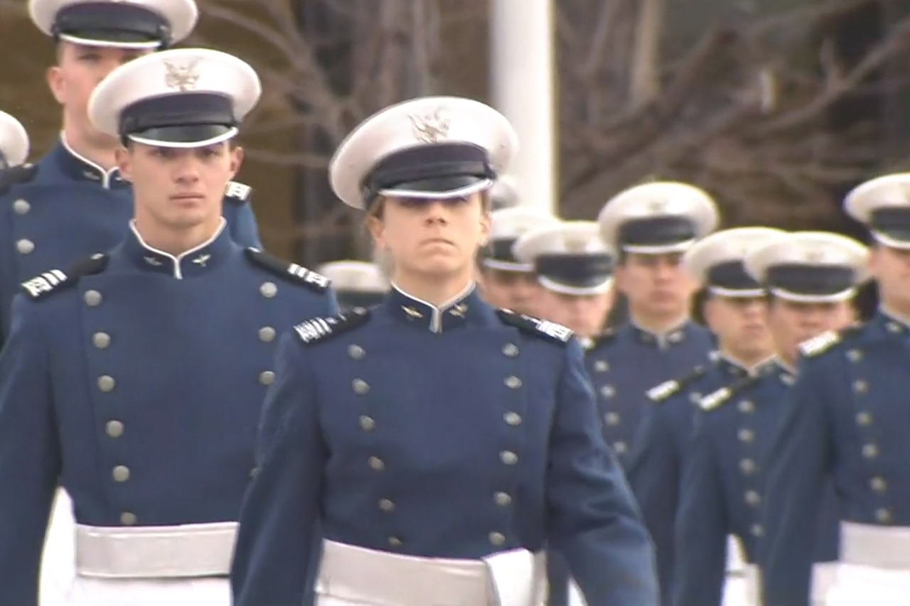 Formation of cadets stands at attention.
