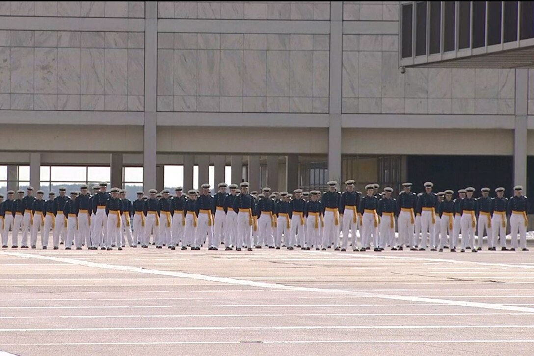 Formation of cadets stands at attention.