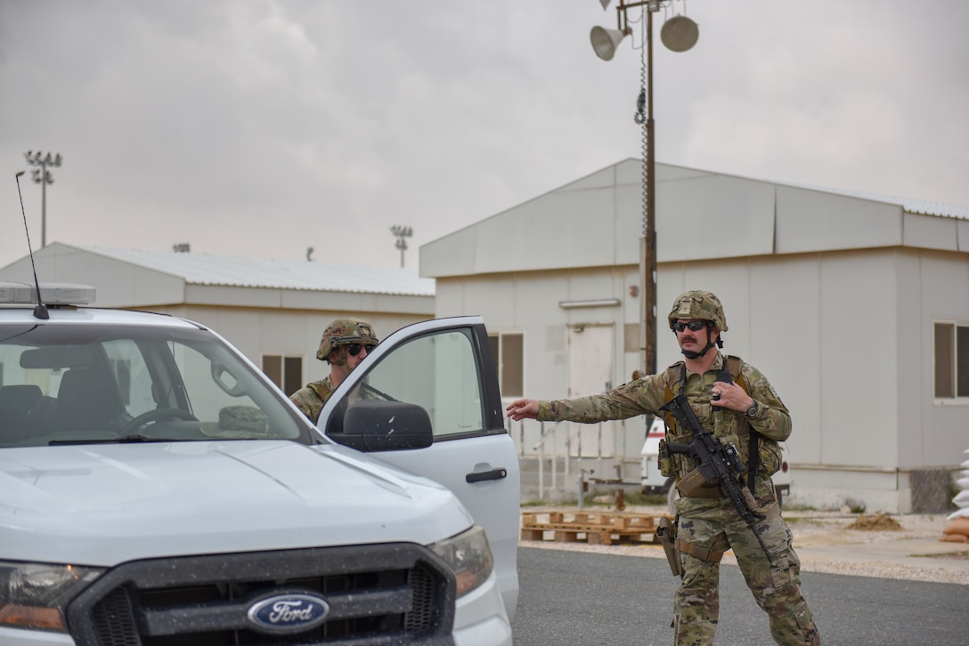 An Airman assigned to the 379th Expeditionary Security Forces Squadron cordons off an area during a theater ballistic missile exercise at Al Udeid Air Base, Qatar on April 16, 2020. The 379th Air Expeditionary Wing regularly conducts exercises at AUAB to maintain readiness in a deployed environment. This enables the base to sustain air power across the U.S. Central Command area of responsibility.