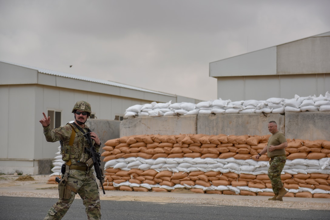An Airman assigned to the 379th Expeditionary Security Forces Squadron cordons off an area during a theater ballistic missile exercise at Al Udeid Air Base, Qatar on April 16, 2020. The 379th Air Expeditionary Wing regularly conducts exercises at AUAB to maintain readiness in a deployed environment. This enables the base to sustain air power across the U.S. Central Command area of responsibility.