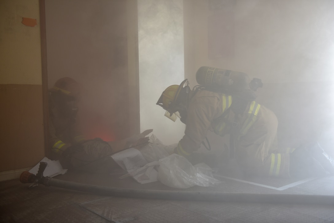 Firefighters assigned to the 379th Expeditionary Civil Engineer Squadron move a simulated casualty through a building during a theater ballistic missile exercise at Al Udeid Air Base, Qatar on April 16, 2020. The 379th Air Expeditionary Wing regularly conducts exercises at AUAB to maintain readiness in a deployed environment. This enables the base to sustain air power across the U.S. Central Command area of responsibility.