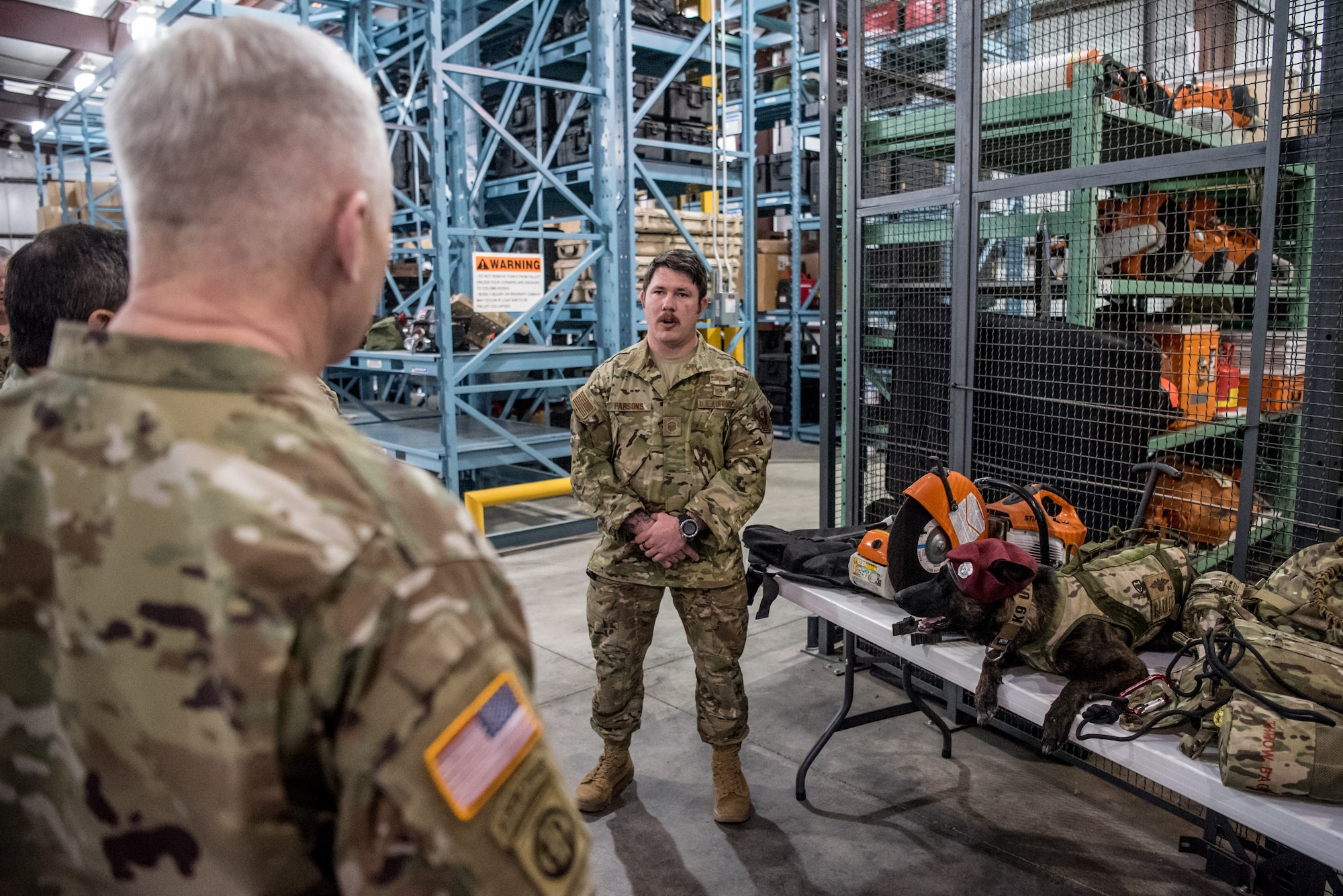 Brig. Gen. Haldane Lamberton (left), Kentucky’s newly appointed adjutant general, learns about the capabilities of Callie (right), the only search-and-rescue dog in the Department of Defense, from Master Sgt. Rudy Parsons (center), a 123rd Special Tactics Squadron pararescueman and Callie’s handler, during a tour of the Kentucky Air National Guard Base in Louisville, Ky., on Jan. 28, 2020. Lamberton visited various work centers, learning about the unique mission sets of the 123rd Airlift Wing. (U.S. Air National Guard photo by Staff Sgt. Joshua Horton)