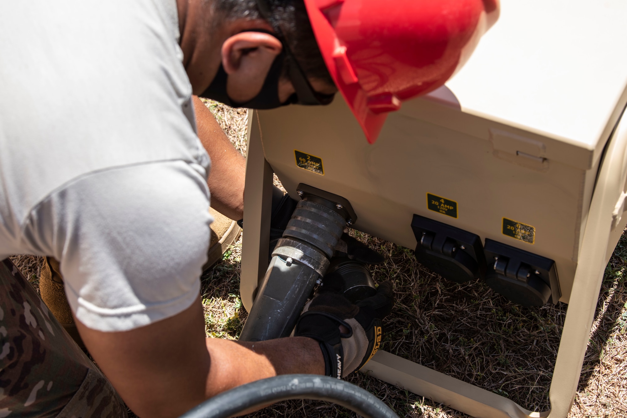An Airman from the 554th RED HORSE Squadron readies a generator for a temporary warehouse unit as part of the construction of an Expeditionary Medical Support System facility April 13, 2020, at U.S. Naval Hospital Guam.