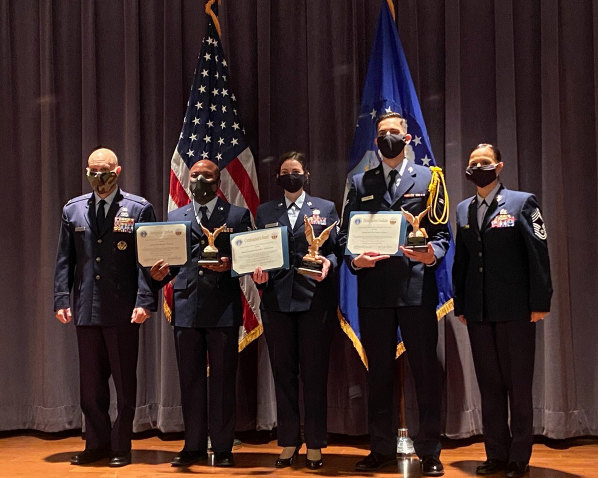 Colonel Christopher Brown, Staff Sgt. Maurice Roberson, other distinguished honor graduates, and Chief Master Sgt. Jenny Green, pose for a photo after Roberson's class's graduation from the Air Force Judge Advocate General School, Montgomery, Alabama. Roberson received the award of distinguished honor graduate for his outstanding performance at technical school. (courtesy photo)