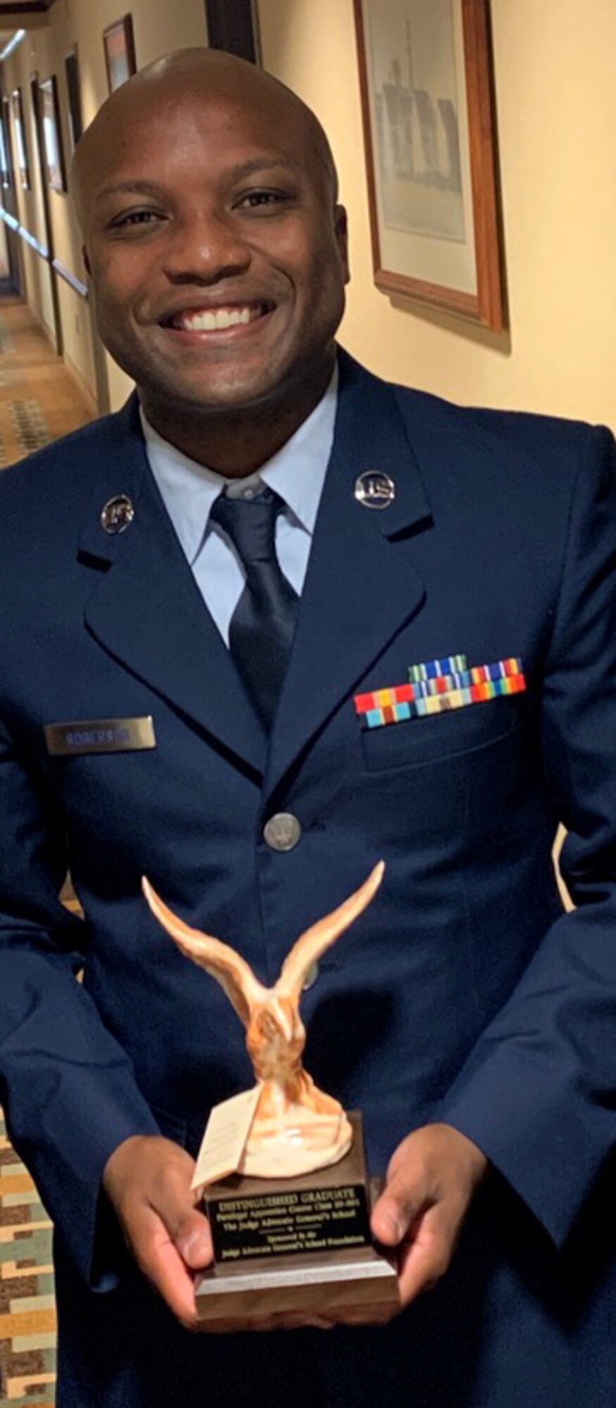Staff Sgt. Maurice Roberson, 104th Fighter Wing paralegal, poses for a photo with his distinguished honor graduate trophy after graduating from the Air Force Judge Advocate General School, Montgomery, Alabama. Roberson received the award of distinguished honor graduate for his outstanding performance at technical school. (courtesy photo)