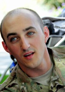 White male in green camouflage uniform.