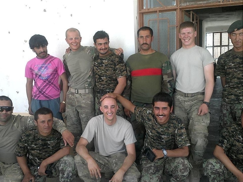 Eleven men pose for picture. Four American Soldiers and seven host nation Afghan Soldiers.