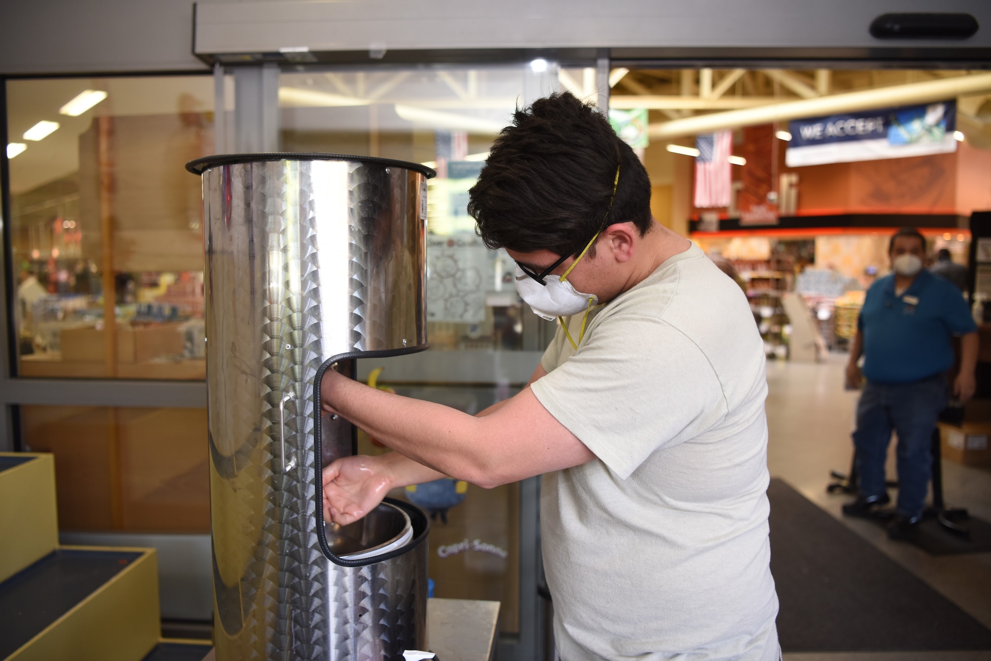 .S. Air Force Senior Airman Israel Garza, 721st Aircraft Maintenance Squadron aerospace propulsion journeyman, washes his hands before entering the commissary at Ramstein Air Base, Germany, April 14, 2020.