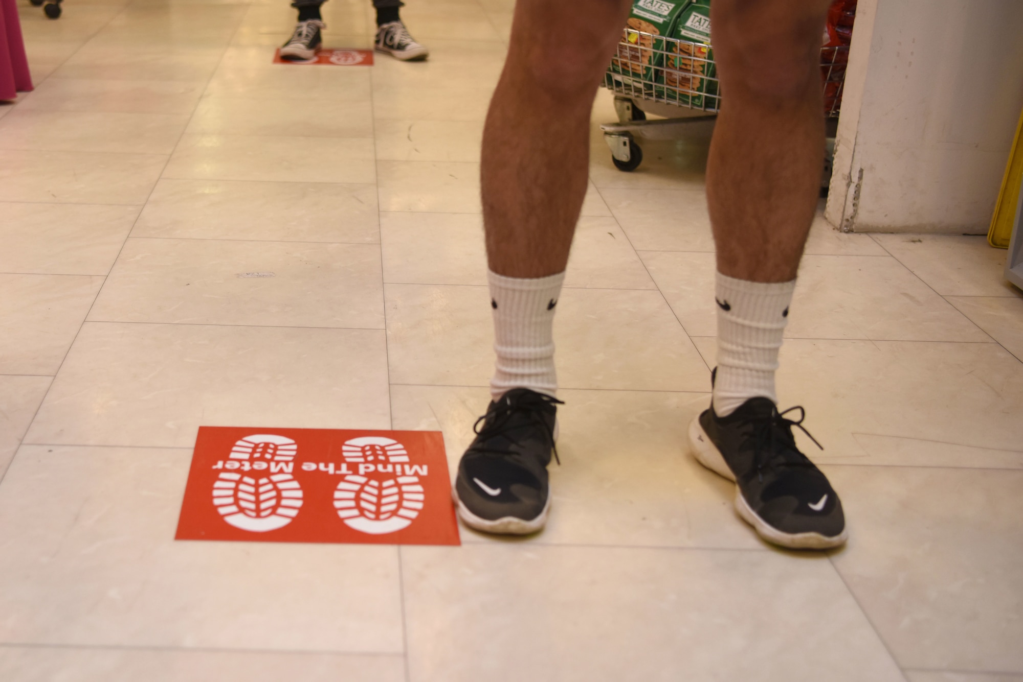 Customers adhere to physical distancing while standing in line in the Exchange at Ramstein Air Base, Germany, April 14, 2020.