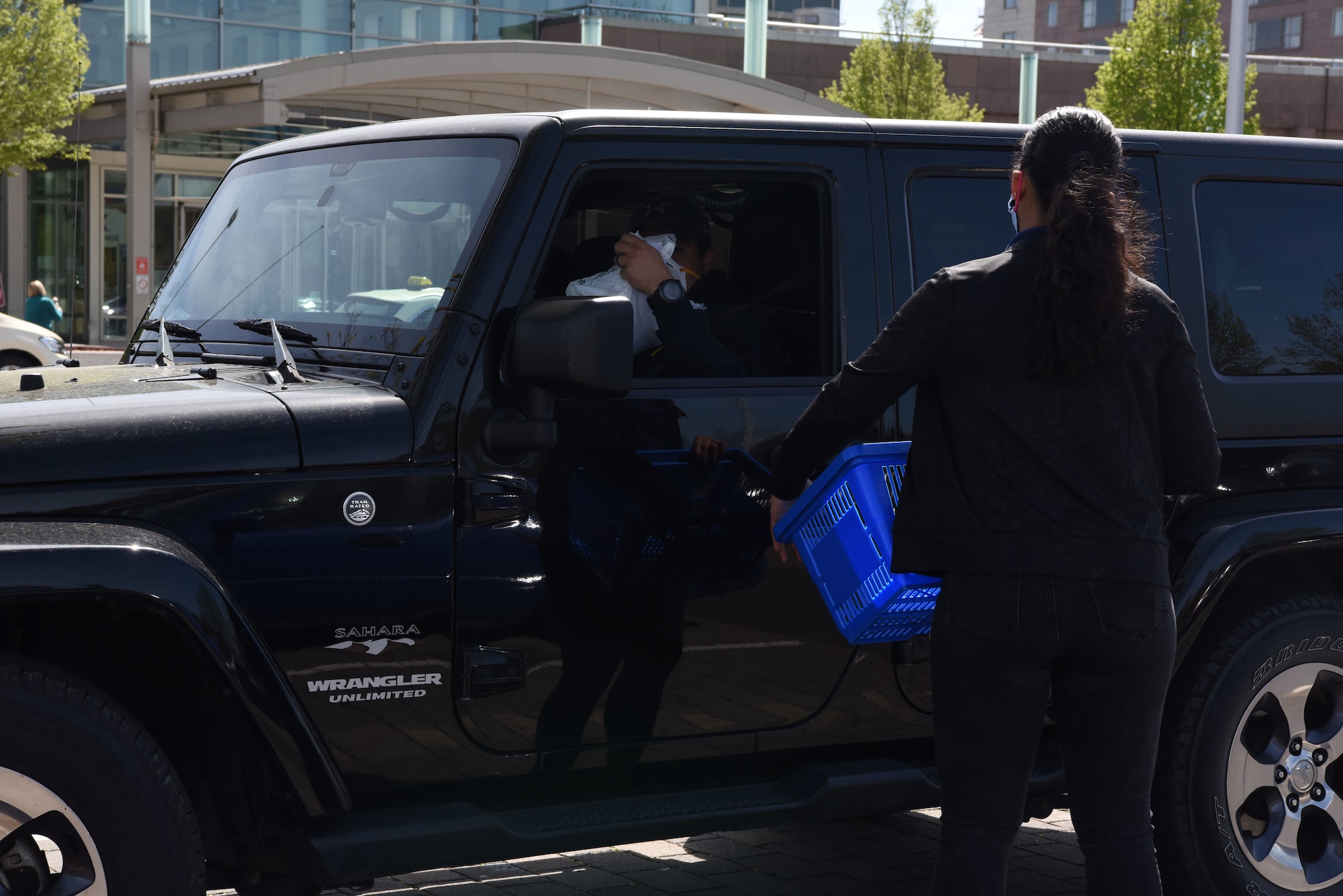 A customer receives goods from an Army and Air Force Exchange Service employee in the Exchange parking lot at Ramstein Air Base, Germany, April 15, 2020.