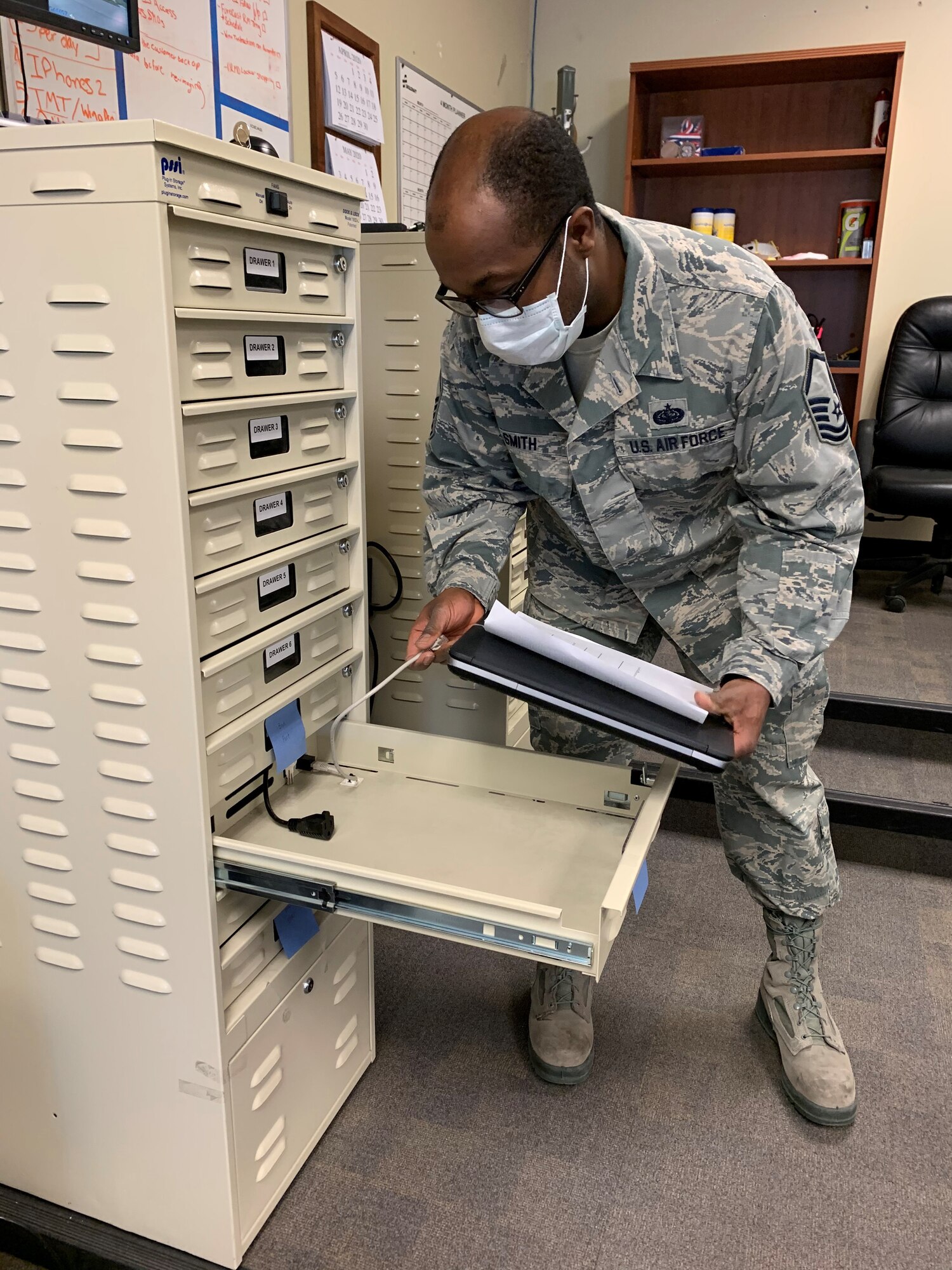 Master Sgt. Dayton Smith, 419th Cyber Flight, removes a laptop from an imaging station, which is used to maintain network access for computers sent to the flight for repairs or updates.