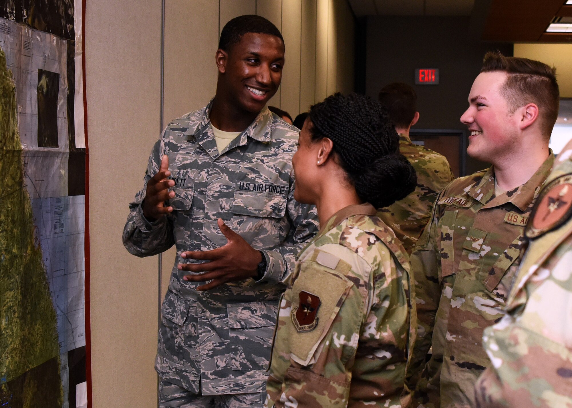 U.S. Air Force students from the 315th Training Squadron explore maps during Operation Lonestar, the capstone project for the four pipeline intelligence analyst students, in the 313th Training Squadron schoolhouse on Goodfellow Air Force Base, Texas, March 5, 2020. One scenario focuses on major combat operations involving the four competitors identified in the National Defense Strategy. Note: This photo was taken before COVID-19 reached Goodfellow, the students and instructors are now practicing precautions and proper safety measures during the capstone. (U.S. Air Force photo by Airman 1st Class Abbey Rieves)