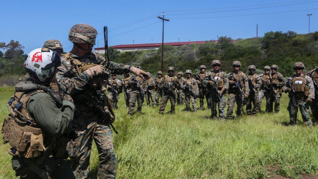 U.S. Marines with Marine Medium Tiltrotor Squadron 165, Marine Aircraft Group 16, 3rd Marine Aircraft Wing (MAW), and 2nd Battalion, 4th Marine Regiment, 1st Marine Division, prepare to load a MV-22 Osprey for a Tactical Recovery of Aircraft and Personnel (TRAP) on Marine Corps Base Camp Pendleton, Calif., April 14,2020. The training was held to ensure consistent operational capability, as 3rd MAW remains ready to support short notice, worldwide deployments while following necessary precautions to protect the health of the force. (U.S. Marine Corps photo by Lance Cpl. Jaime Reyes)