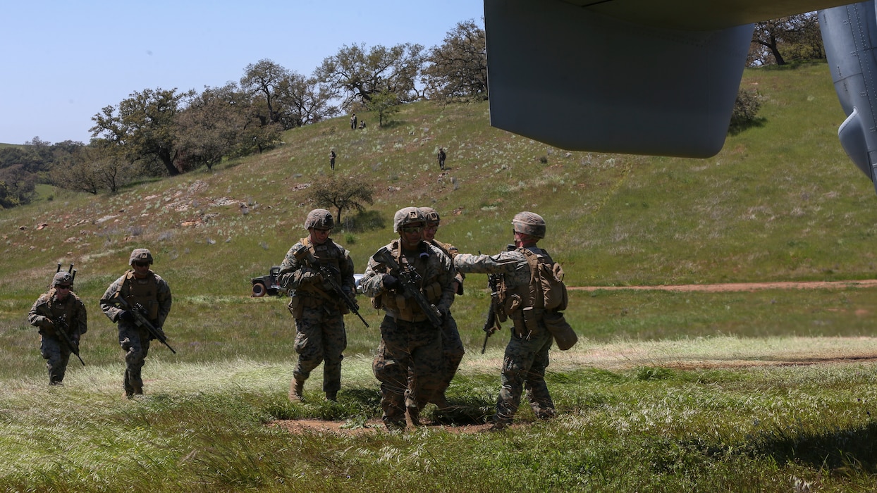 U.S. Marines with Marine Medium Tiltrotor Squadron 165, Marine Aircraft Group 16, 3rd Marine Aircraft Wing (MAW), and 2nd Battalion, 4th Marine Regiment, 1st Marine Division, prepare to load a MV-22 Osprey for a Tactical Recovery of Aircraft and Personnel (TRAP) on Marine Corps Base Camp Pendleton, Calif., April 14,2020. The training was held to ensure consistent operational capability as 3rd MAW remains ready to support short notice, worldwide deployments while following necessary precautions to protect the health of the force (U.S. Marine Corps photo by Lance Cpl. Jaime Reyes)