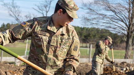 Pfc. Julian Smart, an infantryman with C Company, 3rd of the 172nd Infantry Regiment (Mountain), a Sanbornton resident, digs soil beds in Manchester at the New Hampshire Food Bank garden.