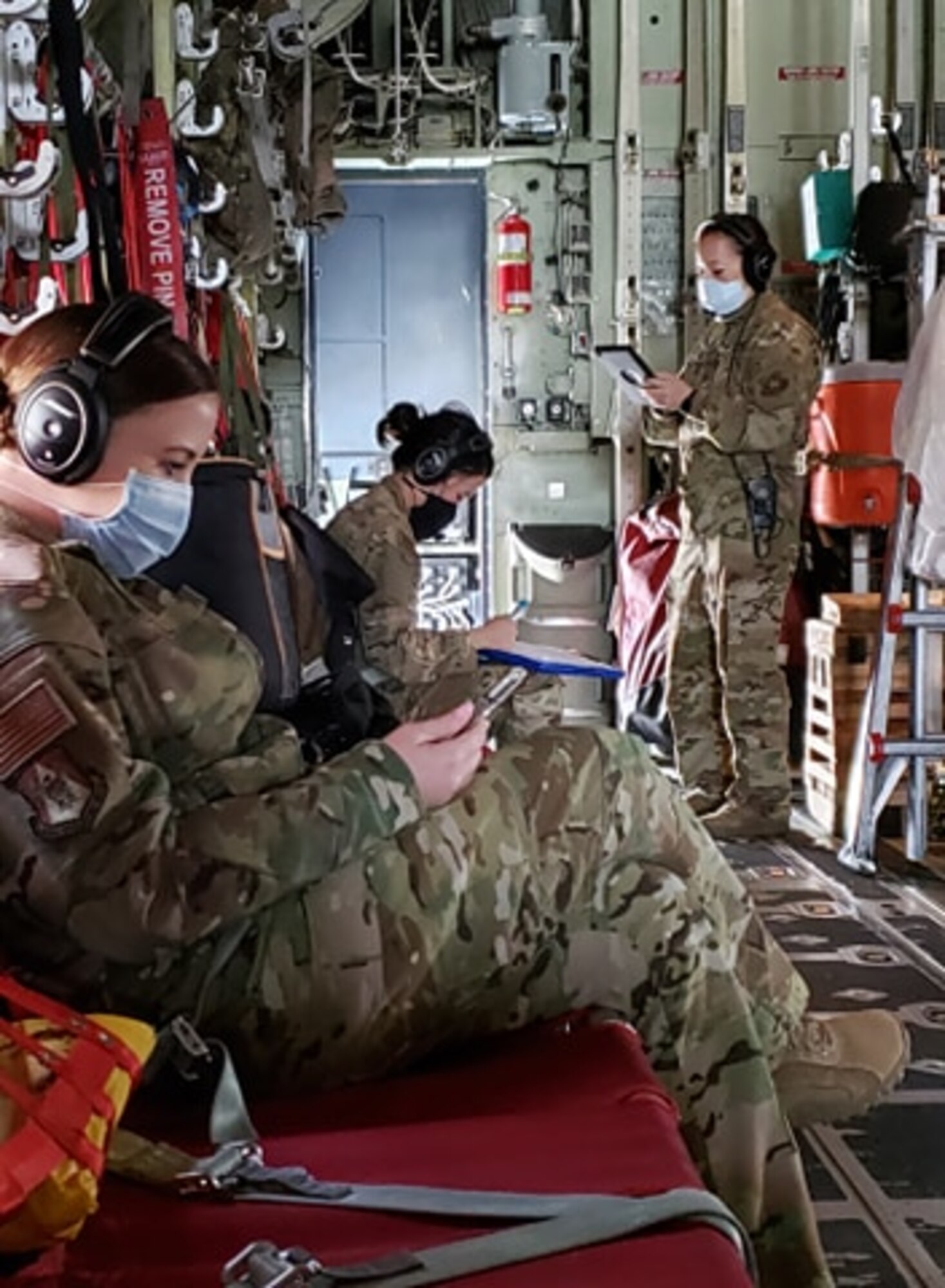 Airmen sit in aircraft