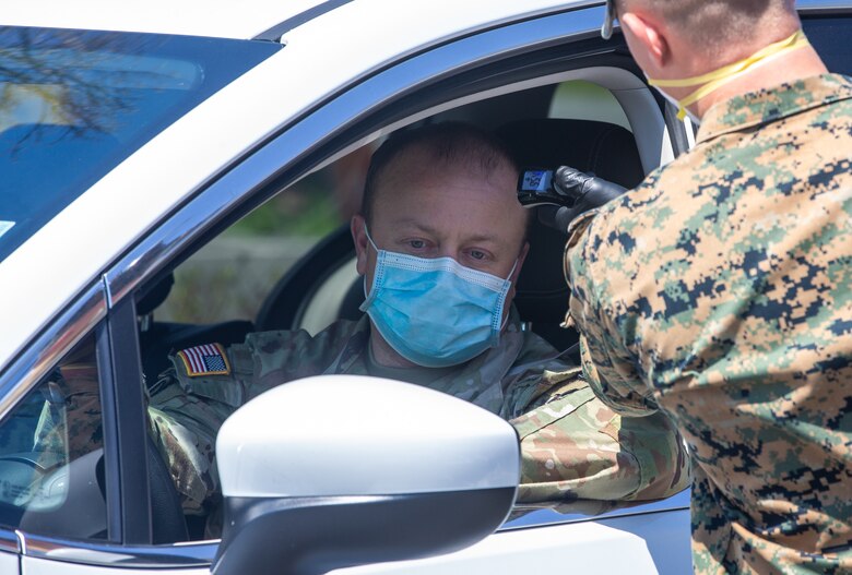 Lance Cpl. Wayne Parsons, a rifleman with Lima Company, 3rd Battalion, 2nd Marines, Task Force New York, checks personnel’s temperature while providing security for the USNS Comfort (T-AH 20) during COVID-19 relief efforts in New York City, April 19, 2020. Comfort cares for trauma, emergency and urgent care patients without regard to their COVID-19 status. Comfort is working with the Javits New York Medical Station as an integrated system to relieve the New York City medical system, in support of U.S. Northern Command's Defense Support of Civil Authorities as a response to the COVID-19 pandemic. (U.S. Marine Corps photo by Sgt. Stormy Mendez)