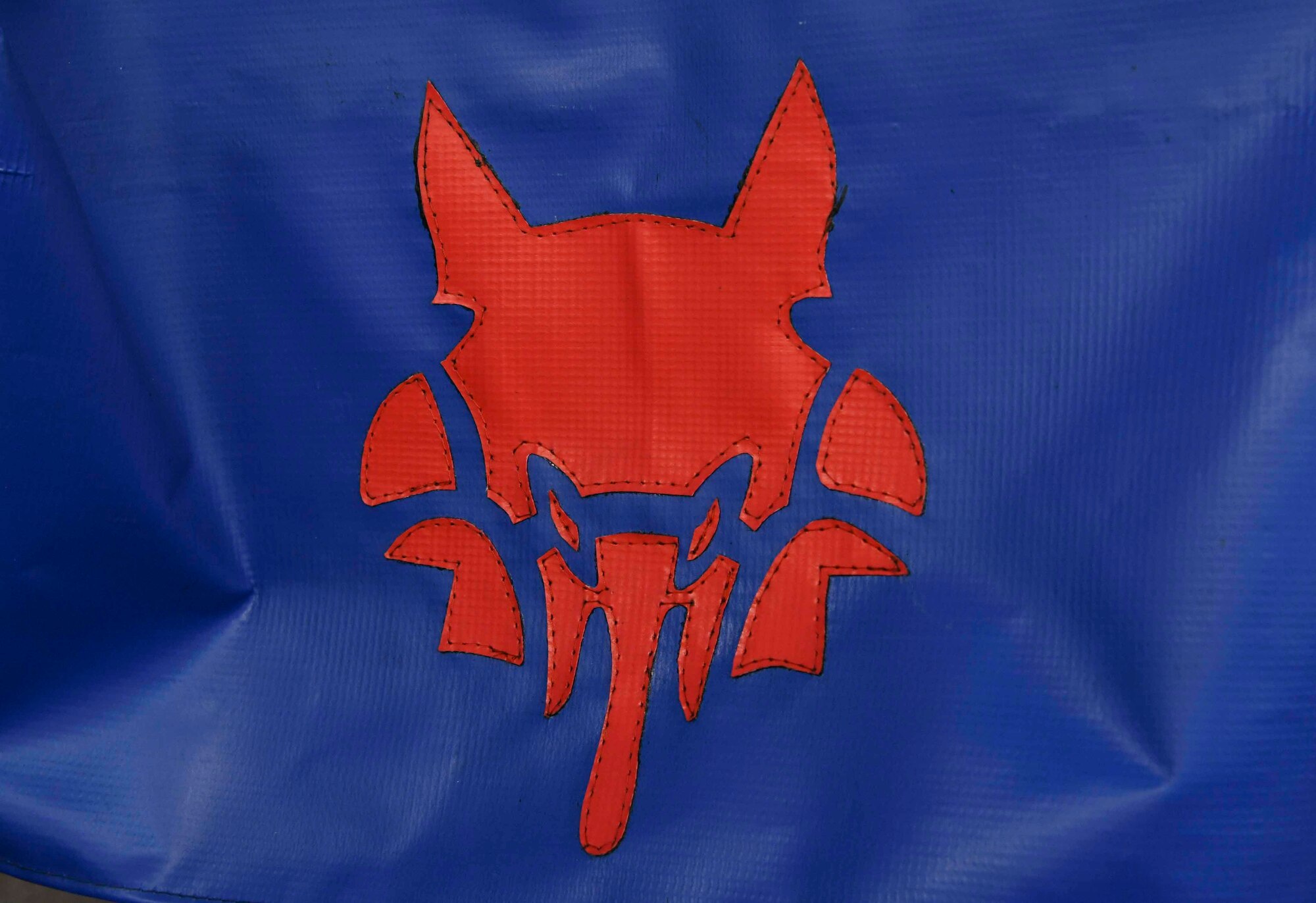 A SAM Fox logo, the logo of the 89th Airlift Wing, is displayed on a sewing machine cover at Joint Base Andrews, Md., Apr. 16, 2020. The 89th Maintenance Group has been fabricating facemasks using their sewing machines to help fill the shortage on JBA. The Centers for Disease Control and Prevention recommends wearing cloth face coverings in public settings where social distancing measures are difficult to be maintained. (U.S. Air Force photo by Airman 1st Class Spencer Slocum)