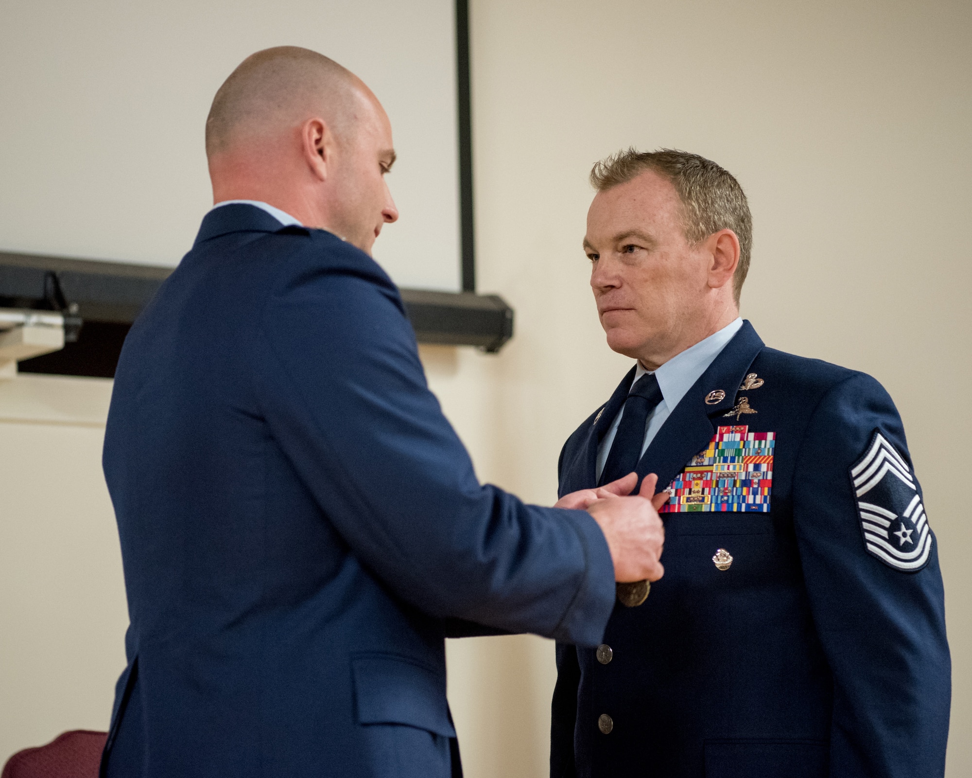 Chief Master Sgt. Aaron May (right), the outgoing chief enlisted manager for the 123rd Special Tactics Squadron, is pinned with the Meritorious Service Medal by Capt. Russ LeMay, Norse Troop officer in charge for the 123rd Special Tactics Squadron, during May’s retirement ceremony at the Kentucky Air National Guard Base in Louisville, Ky., on Dec. 7, 2019. May is retiring after more than 26 years of service to the Kentucky Air National Guard and U.S. Air Force. (U.S. Air National Guard photo by Staff Sgt. Joshua Horton)
