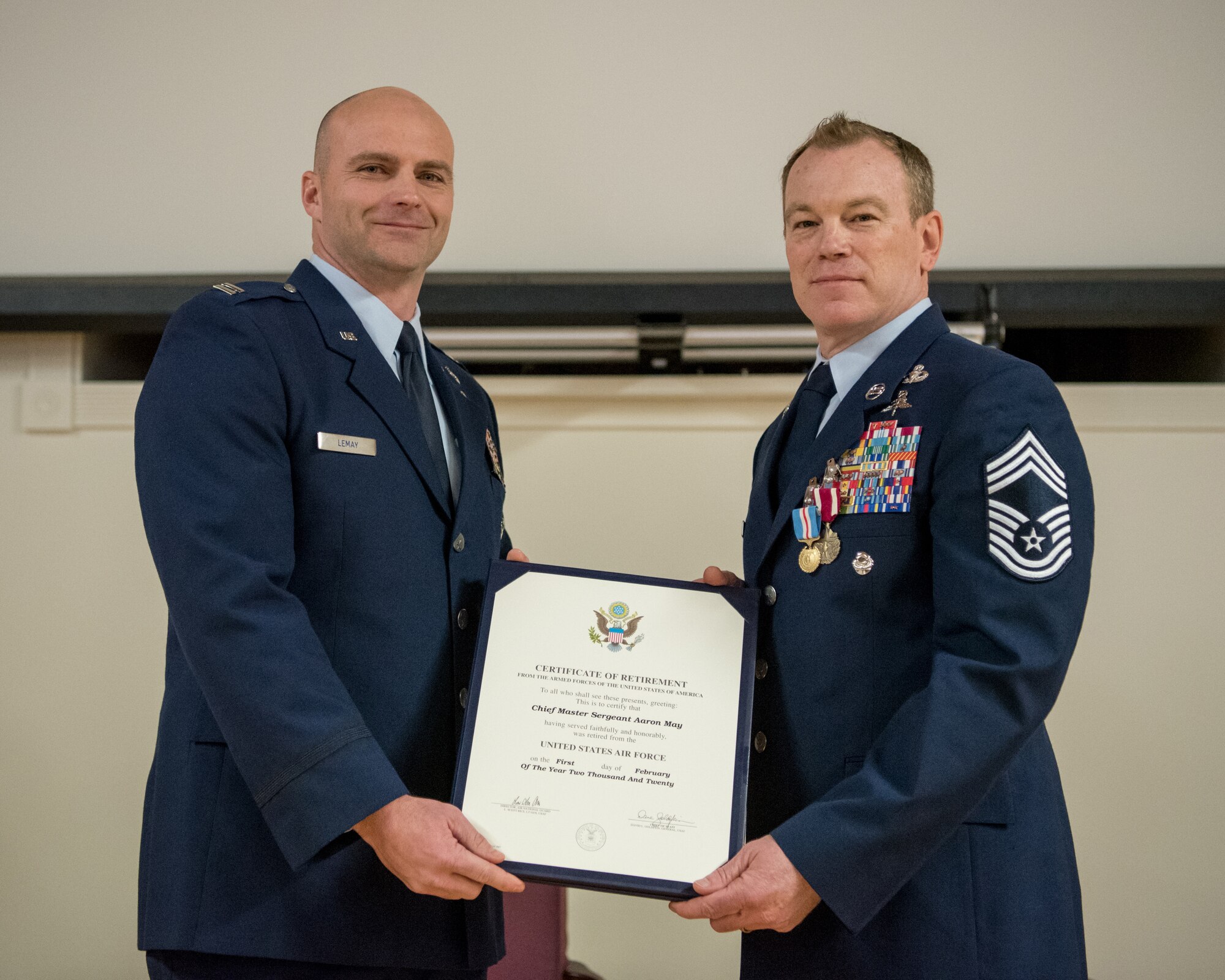 Chief Master Sgt. Aaron May (right), the outgoing chief enlisted manager for the 123rd Special Tactics Squadron, receives his certificate of retirement from Capt. Russ LeMay, Norse Troop officer in charge for the 123rd Special Tactics Squadron, during May’s retirement ceremony at the Kentucky Air National Guard Base in Louisville, Ky., on Dec. 7, 2019. May is retiring after more than 26 years of service to the Kentucky Air National Guard and U.S. Air Force. (U.S. Air National Guard photo by Staff Sgt. Joshua Horton)