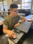 U.S. Marine Corps Lance Cpl. Jeriel Nunez, combat photographer, U.S. Marine Corps Forces, Pacific, works on his laptop, Camp H. M. Smith, Hawaii, Mar. 27, 2020. COVID-19 is a new strain of disease that was discovered in 2019. Prevention and precaution has caused many to begin working from home and take more sanitary measures. (U.S. Marine Corps photo by Lance Cpl. Samantha Sanchez)