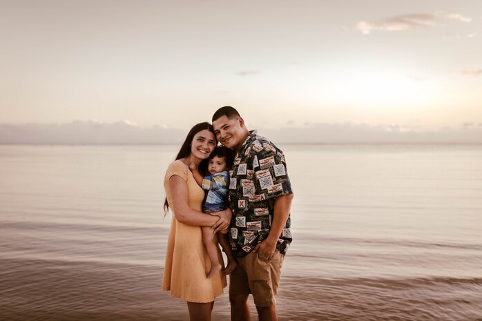 Brianna Figueroa, left, Lincoln Figueroa, center, and U.S. Marine Corps Staff Sgt. Vincent Figueroa, ammunition's operations chief, right, pose for a group photo, North Shore, Hawaii, Mar. 28, 2020. COVID-19 is a new strain of disease that was discovered in 2019. Prevention and precaution has caused many to begin working from home and take more sanitary measures. (U.S. Marine Corps photo courtesy of Cheyenne Williamson)