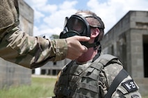 FORT BRAGG, N.C. - Staff Sgt. David Rosa, a psychological operations specialist representing the U.S. Army Civil Affairs and Psychological Operations Command, gets his gas mask checks by a drill sergeant while competing in the combat skills testing event at the 2017 U.S. Army Reserve Best Warrior Competition at Fort Bragg, N.C. June 14. This year’s Best Warrior Competition will determine the top noncommissioned officer and junior enlisted Soldier who will represent the U.S. Army Reserve in the Department of the Army Best Warrior Competition later this year at Fort A.P. Hill, Va. (U.S. Army Reserve photo by Sgt. Jennifer Shick)