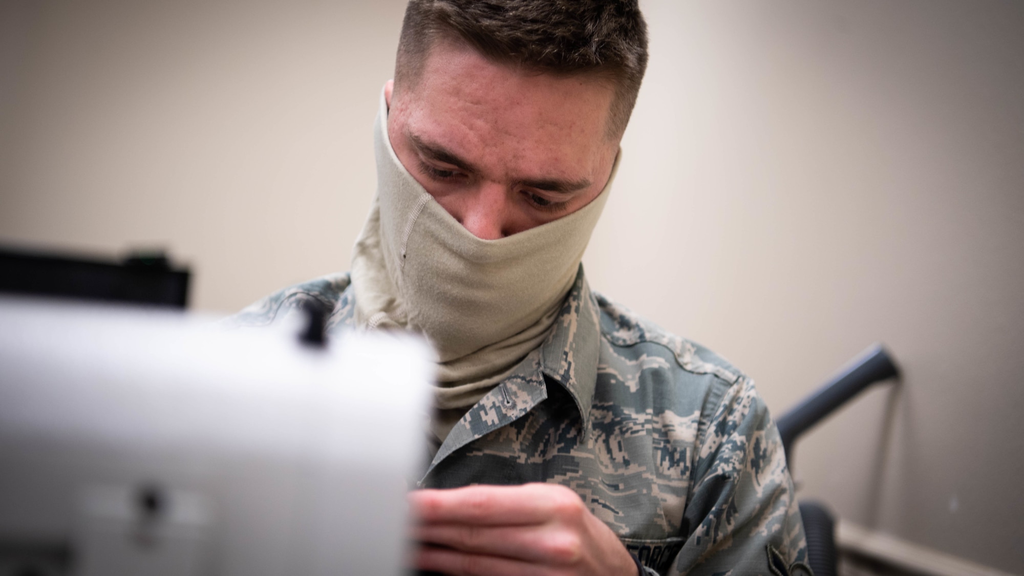 Airman Alexander D. Neurohr, 2nd Operational Support Squadron aircrew flight equipment journeyman, sews a mask at Barksdale Air Force Base, La., April 16, 2020. All Airmen of the 2nd OSS AFE shop learned to sew as part of their technical training to repair aircrew equipment including parachutes, flight suits and other various equipment. (U.S. Air Force photo by Airman 1st Class Jacob B. Wrightsman)