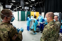 Col. Matthew Bridges, commander of 452-1 Task Force, gives a Joint Task Force New York/New Jersey Commanding General Maj. Gen. William “Bill” Hall tour of Field Medical Station Edison, located in the New Jersey Convention and Exposition Center, April 15, 2020.