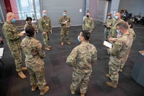 U.S. Air Force Command Chief Master Sgt. James Brown, Task Force New York/New Jersey command senior enlisted leader, holds a senior enlisted huddle to discuss commander priorities and topics that are effecting service members at the Javits New York Medical Station, April 18, 2020.