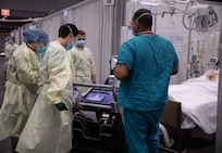 U.S. Army service members from the 531st field hospital, deployed from Fort Campbell, Kentucky examine a patient x-ray results at the Javits New York Medical Station in support of the Department of Defense COVID-19 response, April 18, 2020.