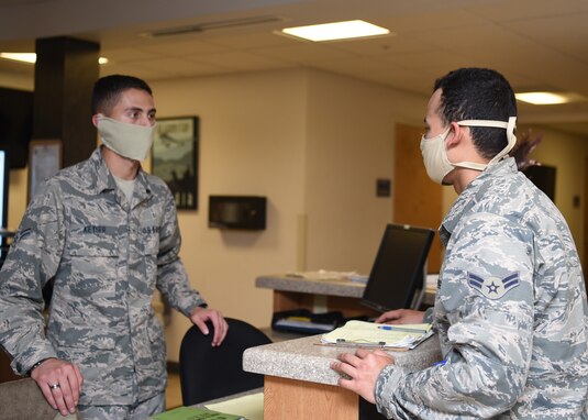 U.S. Air Force Airmen for the 315th Training Squadron discuss daily operations while combating the spread of COVID-19 at the 315th TRS dormitory, on Goodfellow Air Force Base, Texas, April 20, 2020. The Airmen followed the Department of Defense’s guidance, which allowed military members to wear cloth face masks in uniform and practiced COVID-19 preventative measures such as wearing masks, to maintain mission essential operations. (U.S. Air Force photo by Airman 1st Class Abbey Rieves)