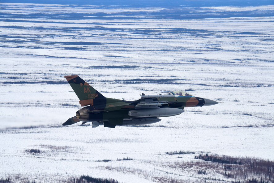 U.S. Air Force Maj. Brandon Nauta, an 18th Aggressor Squadron pilot, flies an F-16 Fighting Falcon over the Joint Pacific Alaska Range Complex, April 17, 2020.