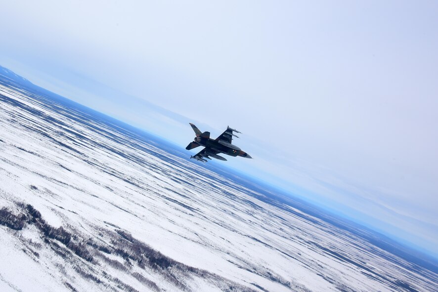 U.S. Air Force Maj. Brandon Nauta, an 18th Aggressor Squadron pilot, flies an F-16 Fighting Falcon over the Joint Pacific Alaska Range Complex, April 17, 2020.