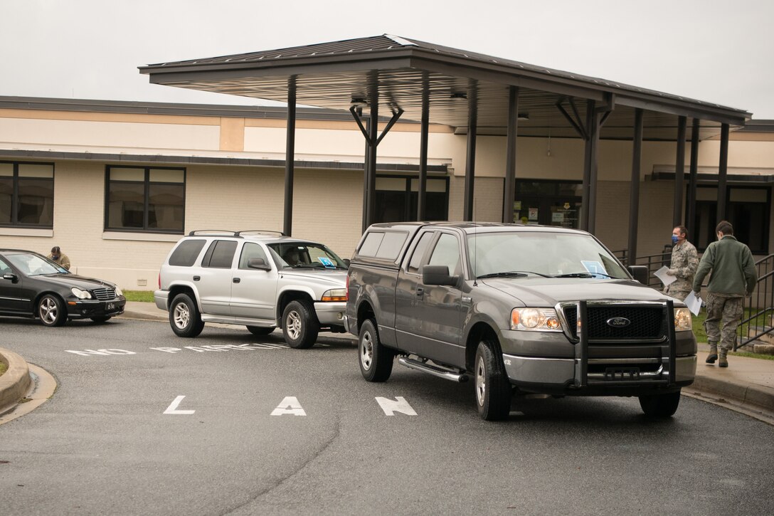 Patrons move through the 436th Medical Group curbside pharmacy, April 18, 2020, at Dover Air Force Base, Delaware. The curbside project offers full pharmacy services including new prescriptions and refills, allowing Team Dover to access prescriptions and maintain social distancing. (U.S. Air Force photo by Mauricio Campino)