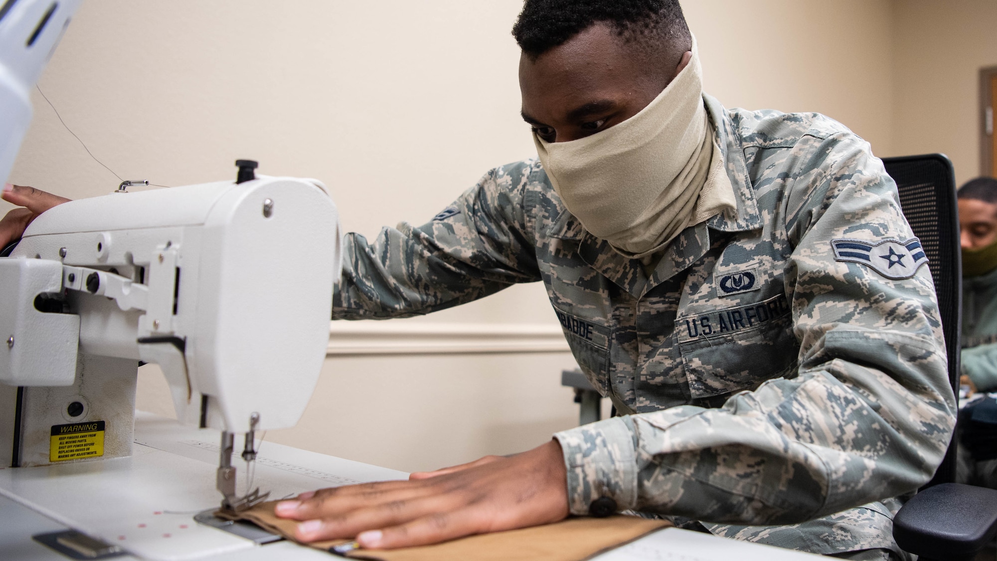 Airman 1st Class David S. Kyambadde, 2nd Operations Support Squadron aircrew flight equipment maintainer, operates a sewing machine to sew face masks at Barksdale Air Force Base, La., April 16, 2020. All Airmen of the 2nd OSS AFE shop learned to sew as part of their technical training to repair aircrew equipment including parachutes, flight suits and other various equipment. (U.S. Air Force photo by Airman 1st Class Jacob B. Wrightsman)