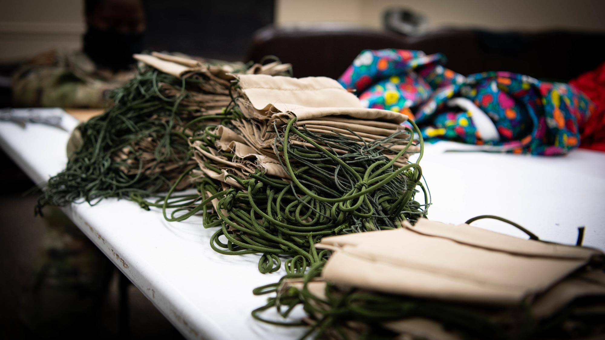 Completed face masks sewn by 2nd Operations Support Squadron Airmen are placed on a table at Barksdale Air Force Base, La., April 16, 2020. Mask making material has been donated by Barksdale residents and community partners. (U.S. Air Force photo by Airman 1st Class Jacob B. Wrightsman)