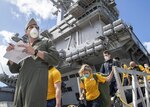 U.S. Sailors assigned to the aircraft carrier USS Theodore Roosevelt (CVN 71) depart the ship to move to off-ship berthing April 10, 2020. Upon arriving in Guam March 27, Theodore Roosevelt established an Emergency Command Center, initiated a roving and deep cleaning team, and continually educated the crew on social distancing and proper protective procedures and behaviors, to assist the crew in mitigating and controlling the spread of COVID. Theodore Roosevelt is in Guam for a scheduled port visit for resupply and crew rest during their scheduled deployment to the Indo-Pacific.