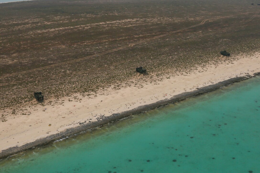 Assault amphibious vehicles assigned to Golf Company, Battalion Landing Team 2/8, 26th Marine Expeditionary Unit, stage on the beach of Karan Island, Saudi Arabia, April 20, 2020. The Bataan Amphibious Ready Group and 26th MEU are conducting routine sustainment training in the U.S. 5th Fleet area of operations in order to enhance the Navy-Marine Corps team's ability to employ low-signature, operationally relevant and strategically mobile crisis response forces to project power over key maritime terrain. (U.S. Marine Corps photo by Cpl. Gary Jayne III)