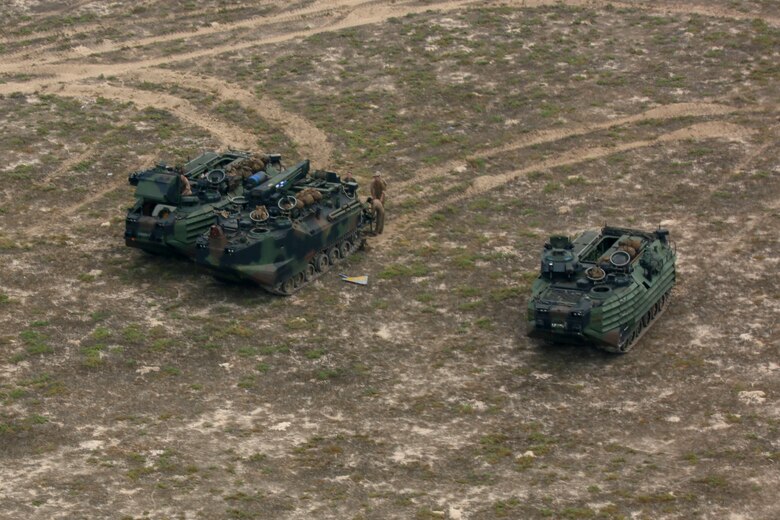 Assault amphibious vehicles assigned to Golf Company, Battalion Landing Team 2/8, 26th Marine Expeditionary Unit, form a command post on Karan Island, Saudi Arabia, April 20, 2020. The Bataan Amphibious Ready Group and 26th MEU are conducting routine sustainment training in the U.S. 5th Fleet area of operations in order to enhance the Navy-Marine Corps team's ability to employ low-signature, operationally relevant and strategically mobile crisis response forces to project power over key maritime terrain. (U.S. Marine Corps photo by Cpl. Gary Jayne III)