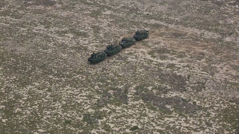 Assault amphibious vehicles assigned to Golf Company, Battalion Landing Team 2/8, 26th Marine Expeditionary Unit, create a formation on Karan Island, Saudi Arabia, April 20, 2020. The Bataan Amphibious Ready Group and 26th MEU are conducting routine sustainment training in the U.S. 5th Fleet area of operations in order to enhance the Navy-Marine Corps team's ability to employ low-signature, operationally relevant and strategically mobile crisis response forces to project power over key maritime terrain. (U.S. Marine Corps photo by Cpl. Gary Jayne III)