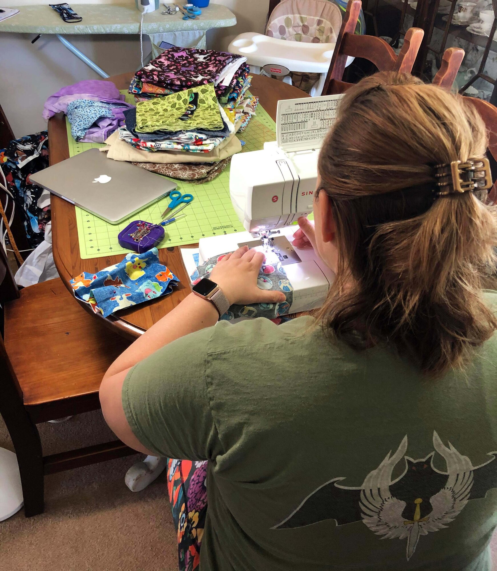 Katie Robertson, Mildenhall Spouses Association member, sews protective masks at her home, April 16, 2020. The fabric used for each mask falls within guidelines of the Department of Defense color restrictions and mirrors the Centers for Disease Control’s instructions on how protective face masks should be made to protect individuals from COVID-19. (Courtesy photo)