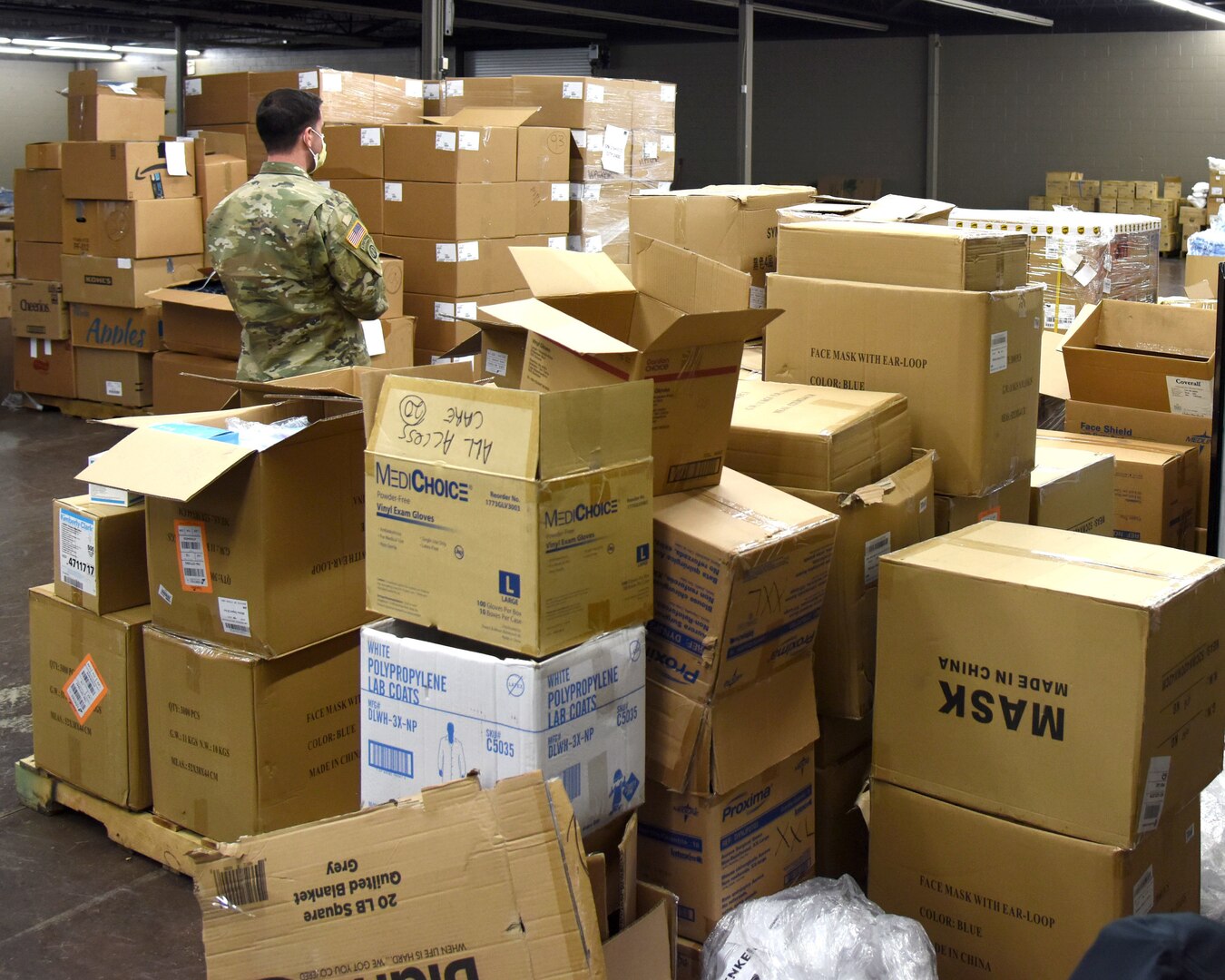 Staff Sgt. Scott Horrigan, 1st Battalion, 125th Regiment, Michigan Army National Guard, works at a Kent County warehouse to help organize and distribute personal protection equipment to medical facilities throughout the state April 15, 2020.